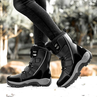 Woman wearing HexoComfy™ Women's Orthopedic High-Top Winter Boots in Black on snow