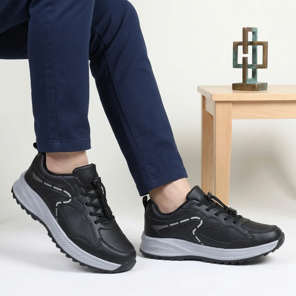 HexoComfy™ Men's Orthopedic Shoes in Black worn while seated beside a side table